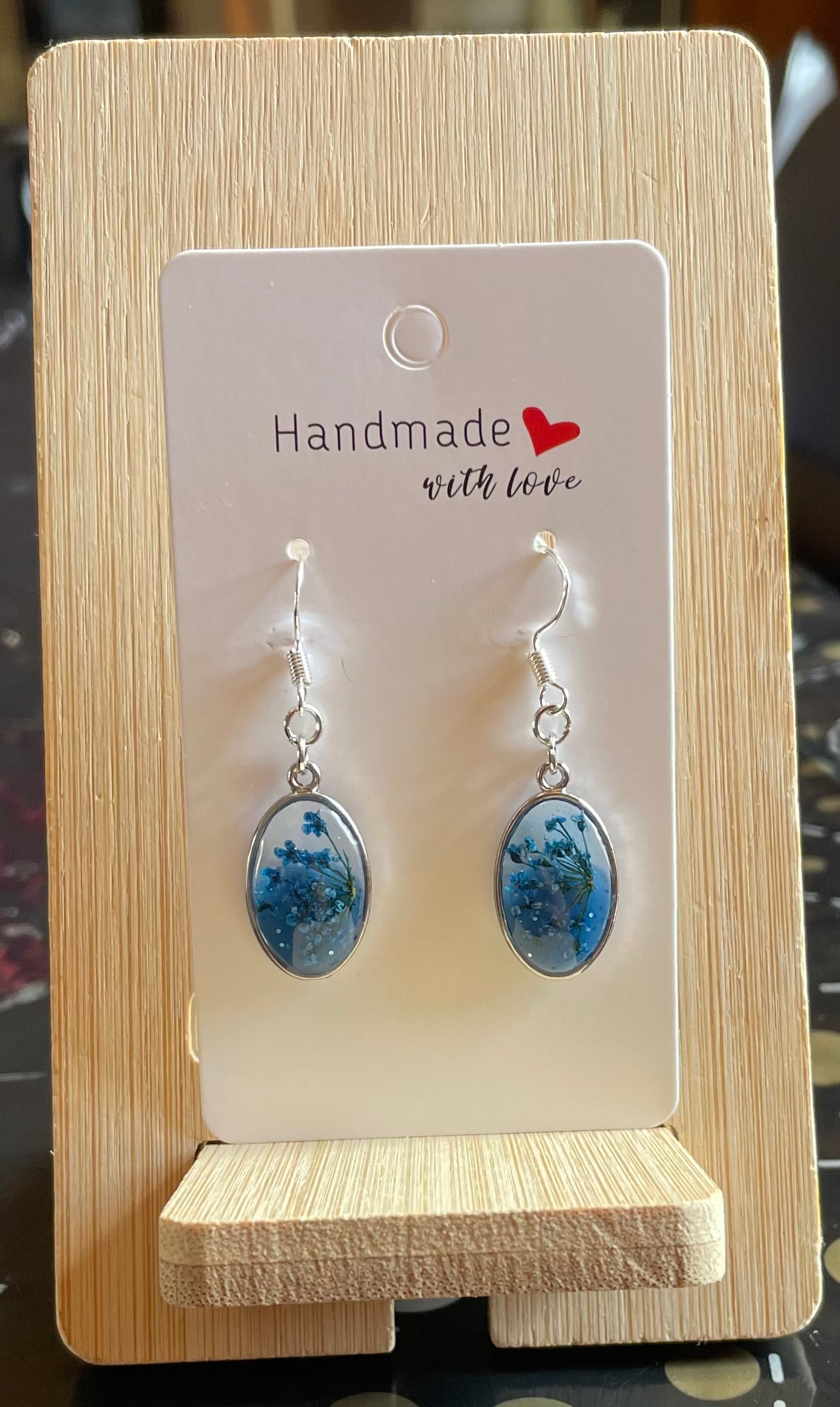 Unique Handmade Oval Shaped Dangly Resin Earrings with Real Flowers in Blue and Clear Resin.