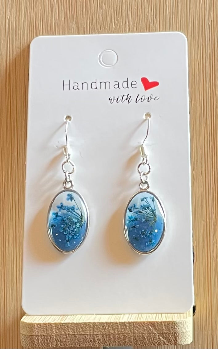 Unique Handmade Oval Shaped Dangly Resin Earrings with Real Flowers in Blue and Clear Resin.