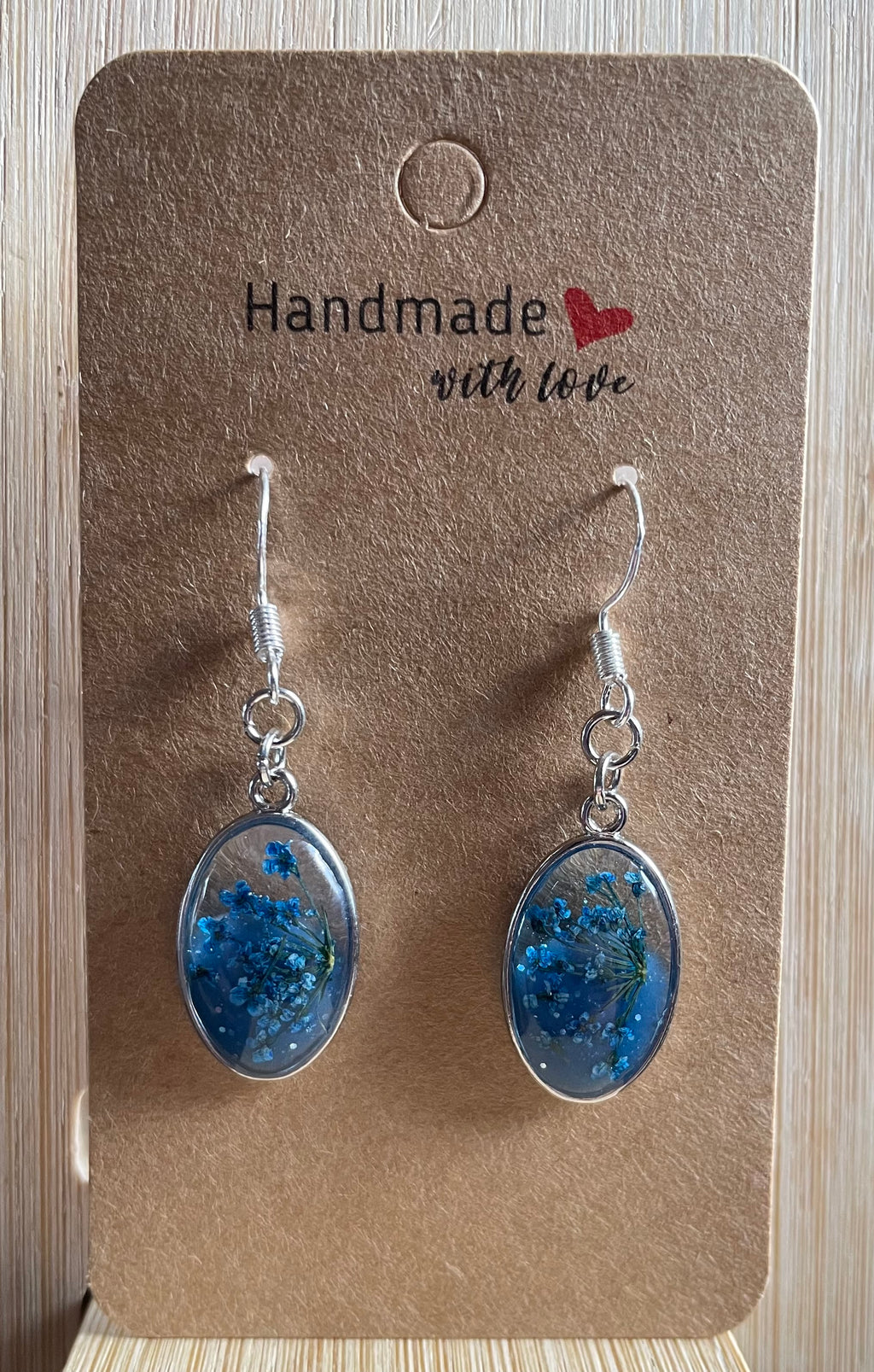 Unique Handmade Oval Shaped Dangly Resin Earrings with Real Flowers in Blue and Clear Resin.